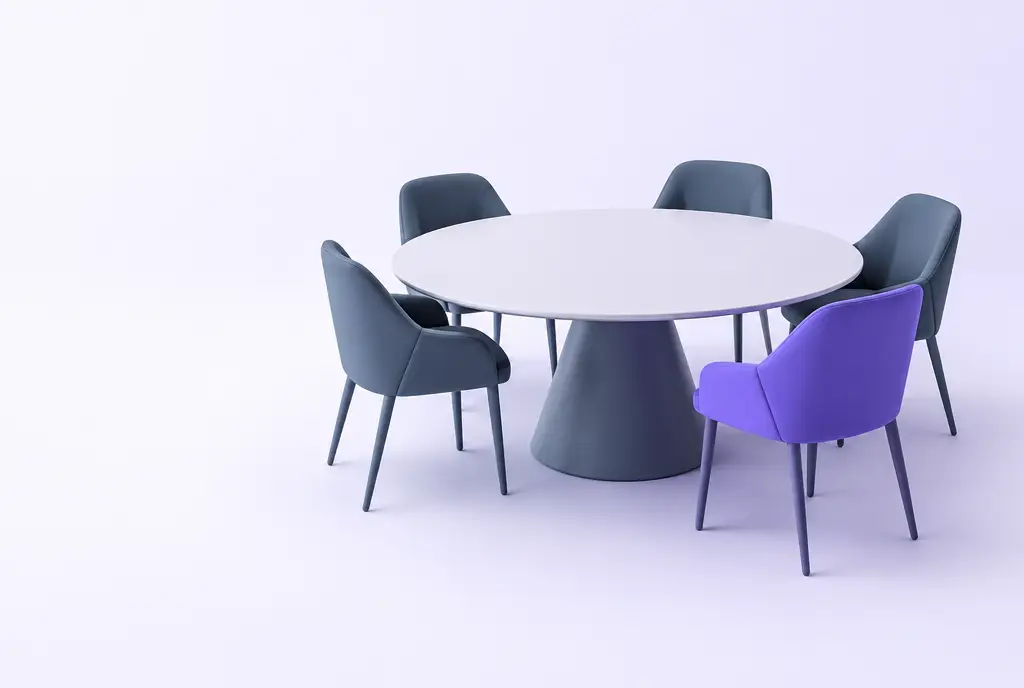 A round table seen at an angle with several slate grey chairs and one violet chair newly placed at it, suggesting pricing earning a seat at the table.